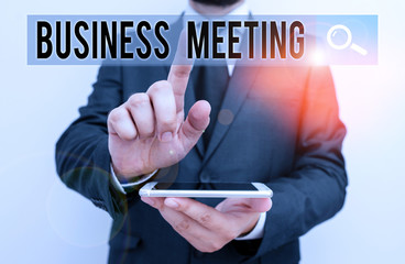 Writing note showing Business Meeting. Business concept for gathering of two or more showing to discuss business ideas Male human wear formal work suit hold smartphone using hand