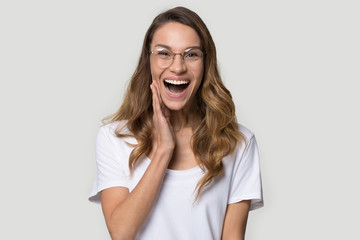 Happy surprised young woman wearing glasses with open mouth