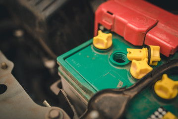 hand of Mechanic Check and Add water to car battery , selective focus auto mechanic uses to check and Maintenance car battery.