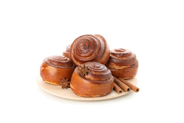 Tasty cinnamon roll with ingredients on plate isolated on white background