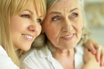 Close up portrait of smiling mother and daughter