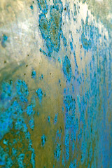 uneven surface with rough peeling paint gold-blue, background