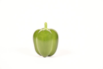On white background a green bell pepper, spicy flavor, used in cooking It is a healthy vegetable and contains vitamins.