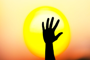 One hand against sun