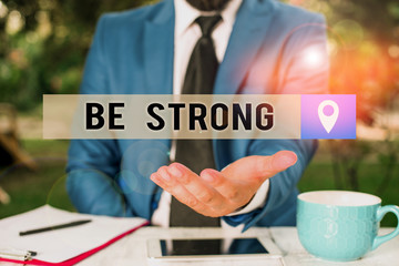 Writing note showing Be Strong. Business concept for able to withstand great circumstances or...