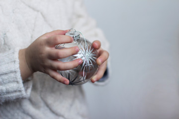  christmas ball  in hands.  christmas toy in hands