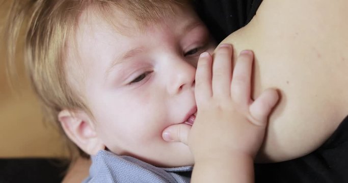 Mom breastfeeds a one-year-old baby