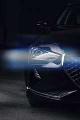 Detail on one of the LED headlights modern car on black background