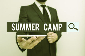 Handwriting text Summer Camp. Conceptual photo supervised program for children conducted during the summer Male human wear formal work suit hold smart hi tech smartphone use one hand