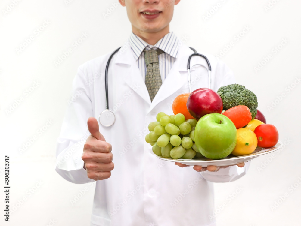 Wall mural doctor nutritionist showing thumbs up, which man dietitian prescribing recipe.healthy eating with wo