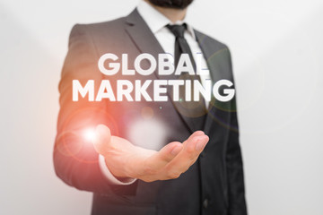 Conceptual hand writing showing Global Marketing. Concept meaning firm sells the same products to...