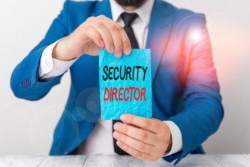 Conceptual hand writing showing Security Director. Concept meaning head of a private security force working for a business Man holds empty paper with copy space in front of him Space