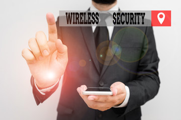 Writing note showing Wireless Security. Business concept for prevention of unauthorized access or damage to computers Male human wear formal work suit hold smartphone using hand