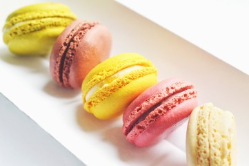 Delicious french macaroons closeup photography. Strawberry, chocolate, pistachio, vanilla and banana macaroons
