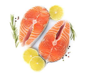 Fresh raw salmon with lemon, pepper and rosemary on white background, top view. Fish delicacy