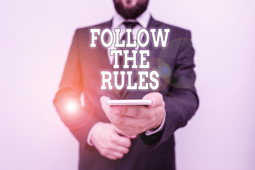 Text sign showing Follow The Rules. Business photo showcasing order someone stick to certain place...