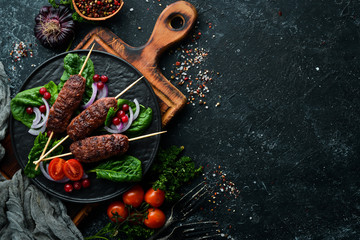 Kebab. Traditional middle eastern, arabic or mediterranean meat kebab with vegetables and herbs....