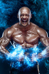 Individual sports recreation. Fit athlete man with dumbbells. Energy and power. Strong muscular guy bodybuilder. Sport and fitness motivation.