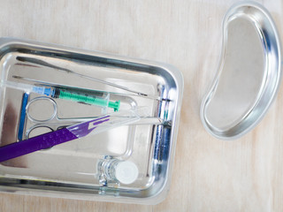 medical instruments in a metal bowl. syringe, tweezers, scalpel. Clean instruments before surgery