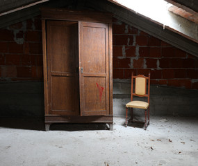 old wooden wardrobe and a vintage chair