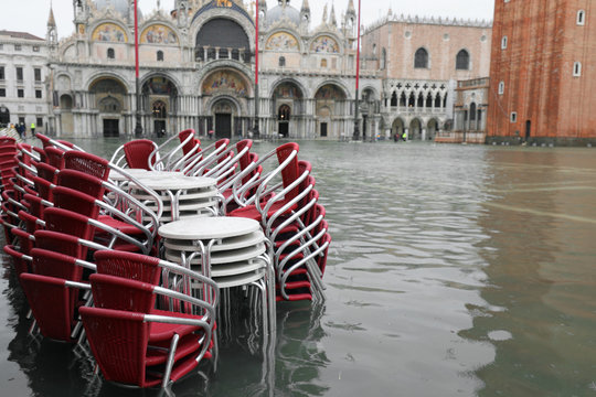 chairs in the flooded Piazza San Marco in Venice during high tid
