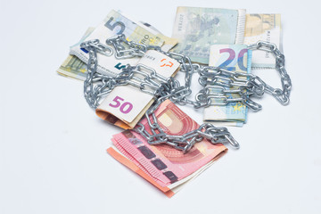 Obraz na płótnie Canvas Dinero encadenado, atados de préstamos bancarios; dinero que esclaviza