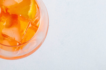 Aperol spritz cocktail glass on white backgorund with oranges. Top View.