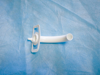 Tracheostomy tube close-up. For emergency care, help close-up. View from above. operation and medicine. Surgeon's tool. scissors closeup. Tracheostomy and laryngeal intubation