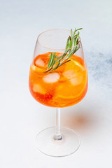 Aperol spritz cocktail glass on white backgorund with oranges. Top View.