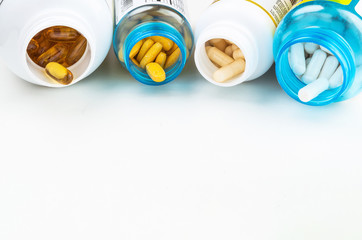 Plastic botlles with vitamin pills on white background