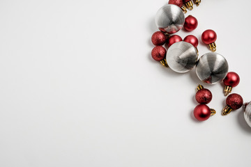 Christmas winter composition. Red and silver balls on white background. Top view, flat lay