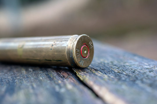 close up of bullet on wooden background