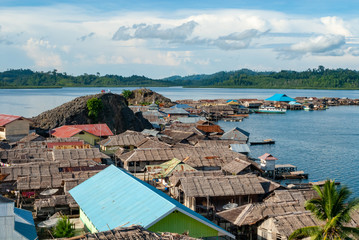 Bajau village built on the wooden poles in the shallow waters of Molluca sea, Sulawesi, Indonesia © salparadis