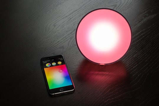 Apple iPhone being used to control a Philips Hue smart home light