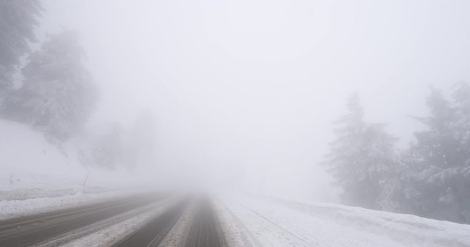 Driving POV personal perspective of covered with snow mountain highway road in German Black Forest mountains safety driving after snow tempest 4K DCI footage