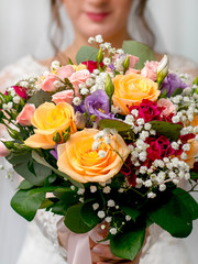 The bride holds a beautiful wedding bouquet in her hands_