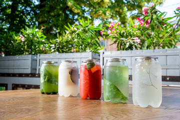 Healthy smoothie from summer fruits and berries in a jars with straws