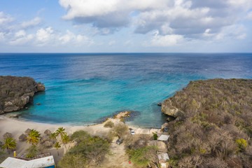 Aerial view of coast of Curaçao in the Caribbean Sea with turquoise water, cliff, beach and beautiful coral reef around Playa Daaibooi