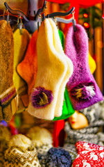 Socks made from wool at stalls during Christmas Market in Riga, Latvia in winter. Street Xmas and holiday fair in European city or town. Advent Decoration with Crafts Items on Bazaar