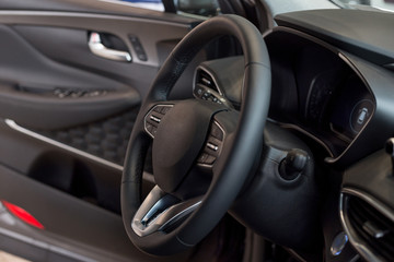 Interior and steering wheel of new modern car.
