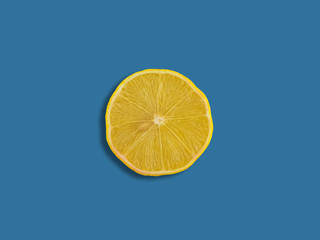 Ripe sliced lemon isolated on a blue background with clipping path. Close-up.