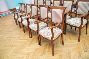 Elite seats, comfortable armchairs, Conference room with brown many armchairs . Many empty armchairs.