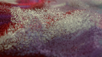 Colored Glitter particles with defocused blur background