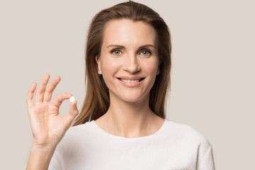 Head shot attractive woman showing tablet, medicine, healthcare concept