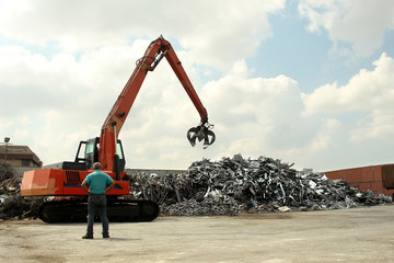  photo of a small crane loading recycling plant