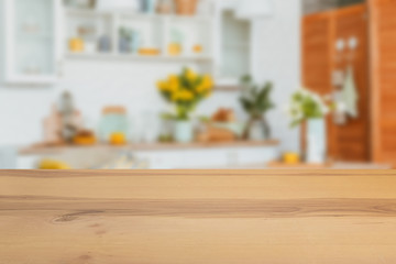 Wooden  table in front of a blurred background. Perspective brown wood with a blurry multi-colored background - can be used to showcase or assemble your products. Mock up to display the product.