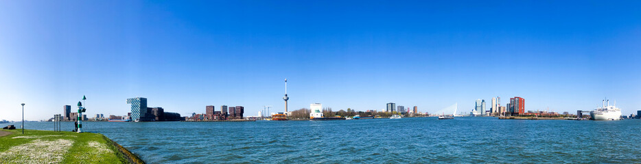 Fototapeta na wymiar panoramic picture of rotterdam skyline at the port, blue sky