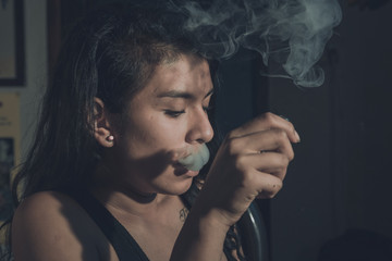 Obraz premium Woman smoking, close up on smoke and mouth