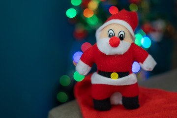 Santa Cluas Christmas composition on the green background  in living room. Beautiful decoration. Christmas trees, candles, stars, lights and elegant accessories. Merry Christmas and Happy Holidays