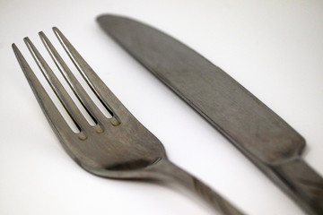 Knife and fork on a white background